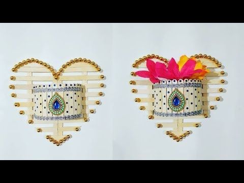 two pieces of art that are made out of wood and metal wire, each with a colorful flower in the center