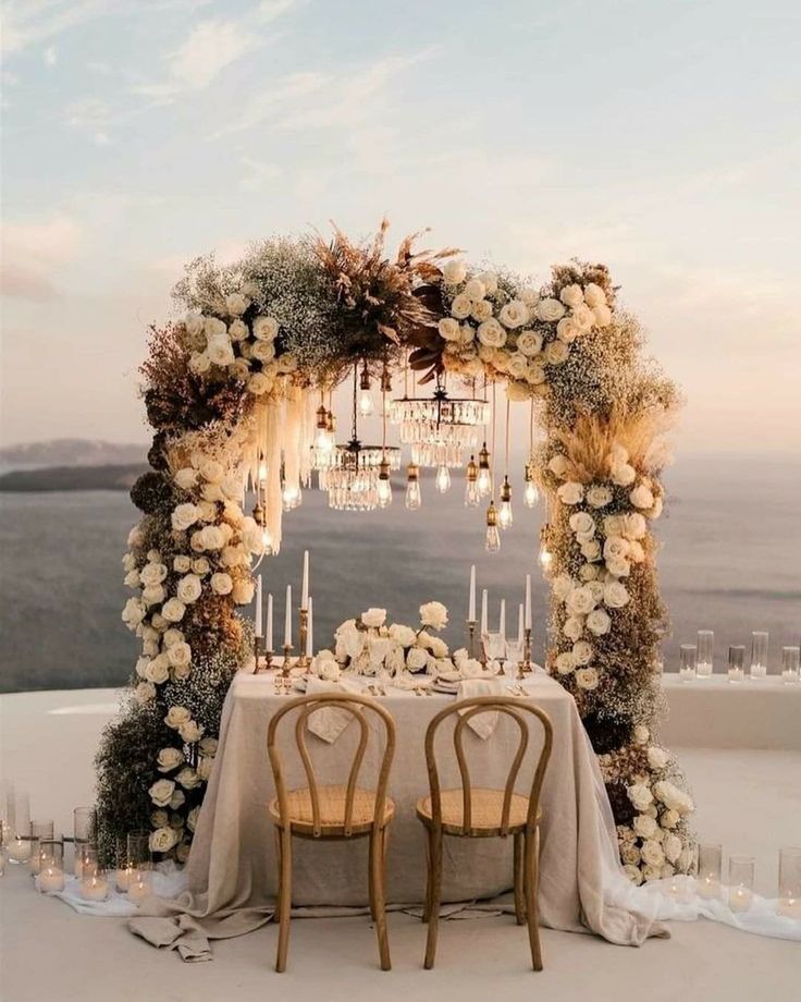 a table with two chairs and a chandelier