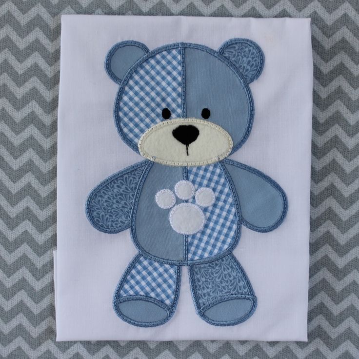 a blue and white teddy bear on a chevron background