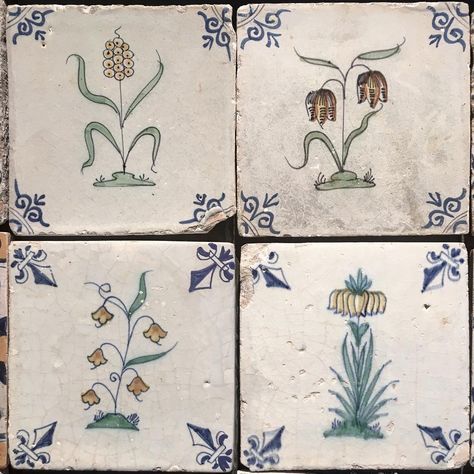 four blue and white tiles with flowers on them