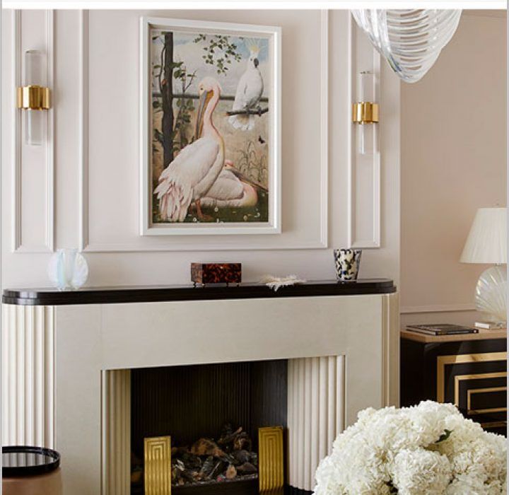 a living room filled with furniture and a painting on the wall above a fire place