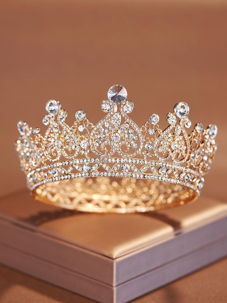 a gold tiara sitting on top of a wooden box