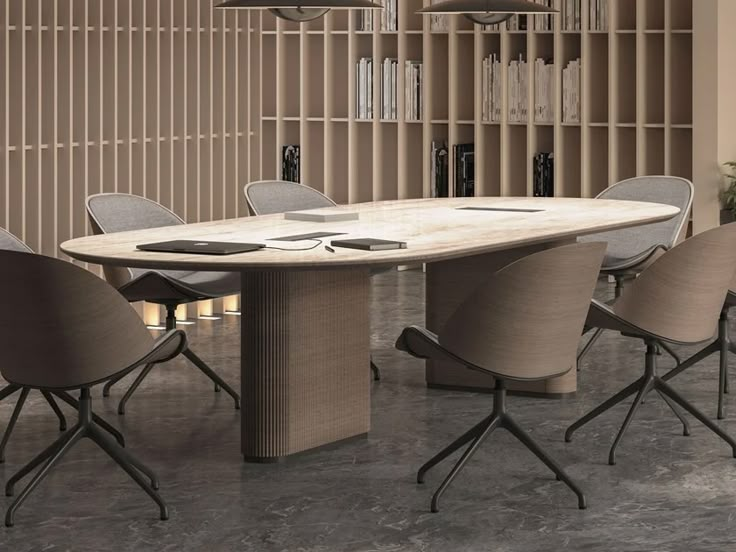 a large table with chairs around it in front of a book shelf filled with books