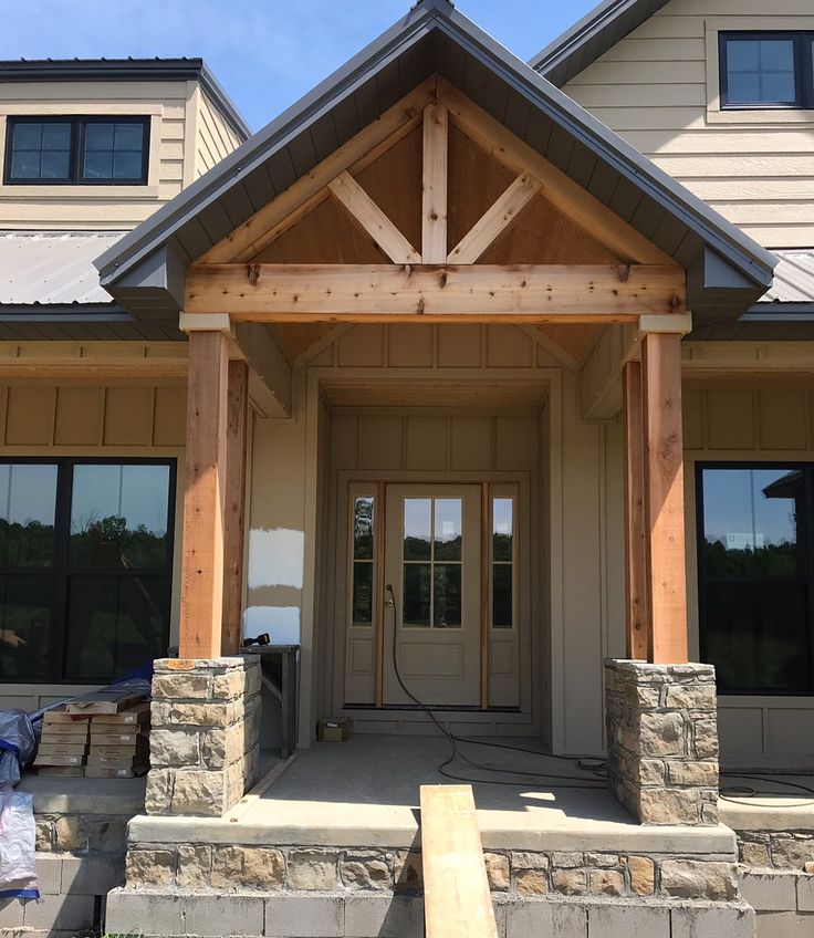 the front entrance to a house with stone pillars