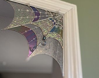 an old stained glass window has been broken and is hanging on the side of a wall