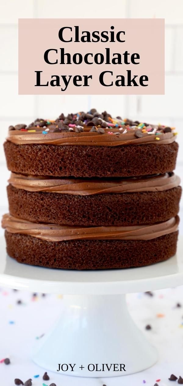 a chocolate layer cake with sprinkles on top and the words classic chocolate layer cake above it