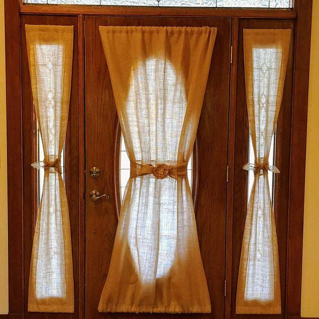 a wooden door with curtains on it