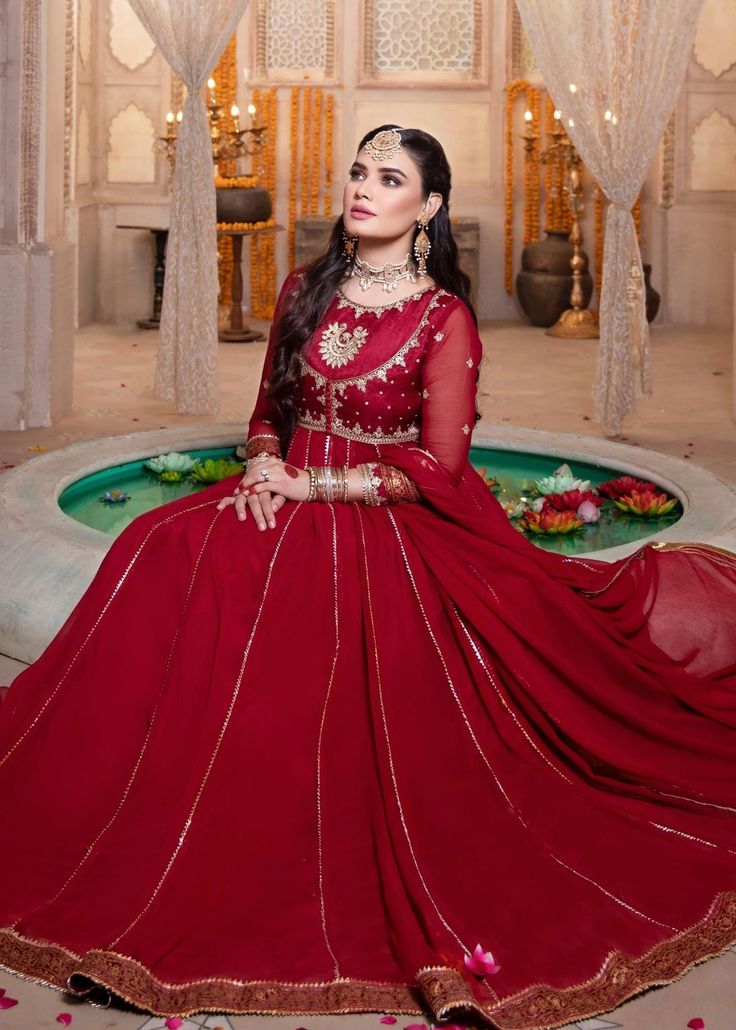 Includes: Kalidar Frock With Inner Attached, Dupatta Fabric: Chiffon Color: Red Work Technique: Embroidered, Embellished Description: . Stay Elegant In This Kalidar Pishwas, Double Neck Bodice, An Exquisitely Ornamental Unique Hue In Chiffon (Stiched With Inner Attached).The Body And Sleeves Are Intricately Embroidered in Resham, Zari & Zardozi. And Further Enhanced With Handmade Buttons On The Bodice. It's Floor Length Kalidar In 185+ Inches Flare, With Detailed Gotta Work In The Panels. Featur Floor Length Dresses Indian, Red Frock, Handmade Buttons, Gotta Work, Pakistani Dresses Casual, Indian Bridal Dress, Red Chiffon, Embroidery Suits Design, Hand Block Print