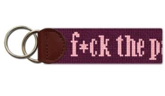 a key chain with the words f k the p on it