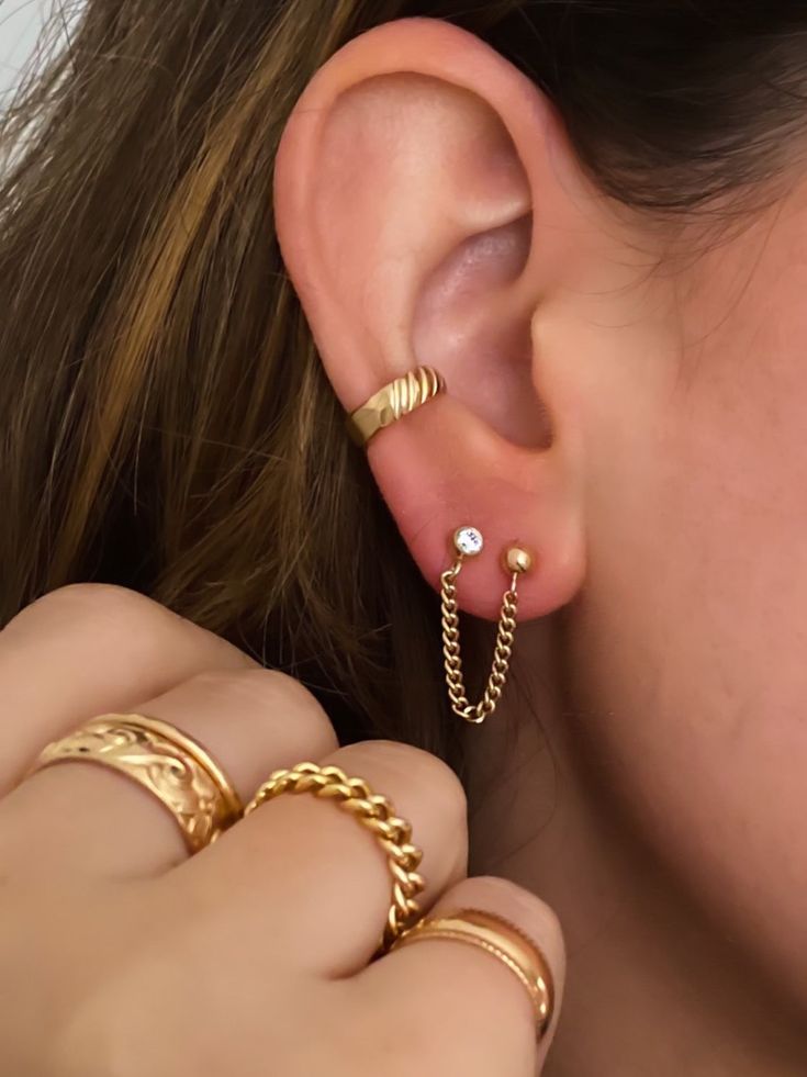 Looking for some edge and a bold look? Add this cuff to your ear stack, no piercing required. Slide onto the conch part of your ear and go. 14k gold filled 3mm width *How to place an ear cuff - a cuff will not fall off if placed correctly. Start by sliding the ear cuff over the top part of your ear ( the thinnest cartilage part) then slide down onto the lower conch. Gently tug to make sure it does not come off. Dainty Tarnish-resistant Ear Cuff For Everyday, Dainty 14k Gold Ear Cuff For Everyday, Everyday Hypoallergenic Gold Plated Ear Cuff, Dainty Gold Stackable Cartilage Earrings, Gold Dainty Stackable Cartilage Earrings, Everyday Stackable Gold Cartilage Earrings, Double Piercing Chain, 2 Piercings, Piercing Chain