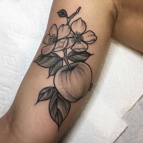 an apple blossom tattoo on the arm