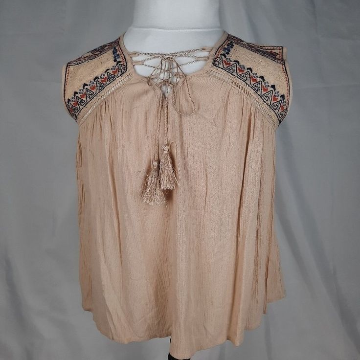 * Alya By Francesca's * Sleeveless Top * Women's Size Small * Embroidered Lace Front & Back Yokes * Taupe Shirt With Blue And Rust Stitching * V-Neck With Draw Cord Lace Up Front * Tassels On Draw Cord * 100% Rayon * Lace: 65% Cotton 35% Nylon * Nwt * Actual Measurements In Inches As Follows * Pit To Pit Laying Flat: 19 * Center Of Rear Neck To Bottom Hem: 23 * Thank You For Shopping * Have A Great Day! * Us Shipping Only * Item T 555 Sleeveless Embroidered Summer Beach Top, Bohemian Tank Top With Floral Embroidery, Bohemian Sleeveless Tank Top With Floral Embroidery, Bohemian Embroidered Tank Top For Vacation, Casual Sleeveless Top With Tassel Ties, Beige Bohemian Sleeveless Blouse, Bohemian Fringe Tank Top For Vacation, Sleeveless Floral Embroidery Vacation Blouse, Bohemian Sleeveless Embroidered Top For Summer