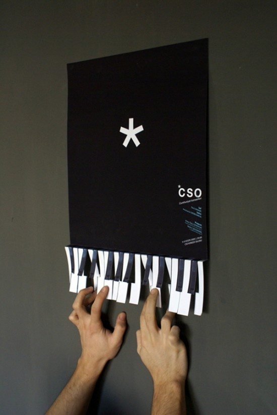 two hands are holding up a sheet of paper that has piano keys and crosses on it