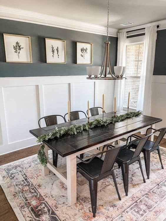 a dining room table with chairs and an area rug in front of the wall that has pictures on it