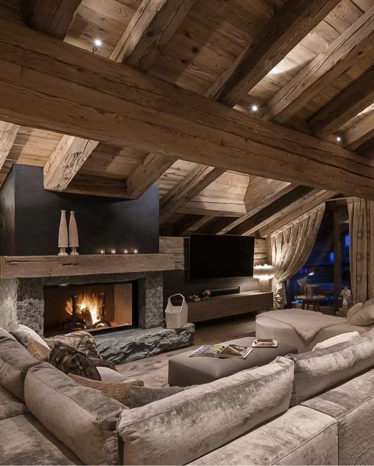 a living room with couches and a fire place in the middle of the room