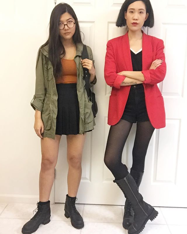 two women standing next to each other in front of a door