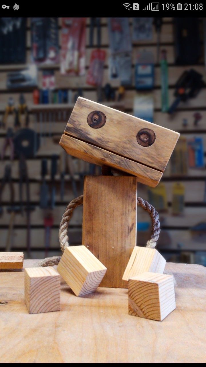 a wooden robot made out of wood blocks