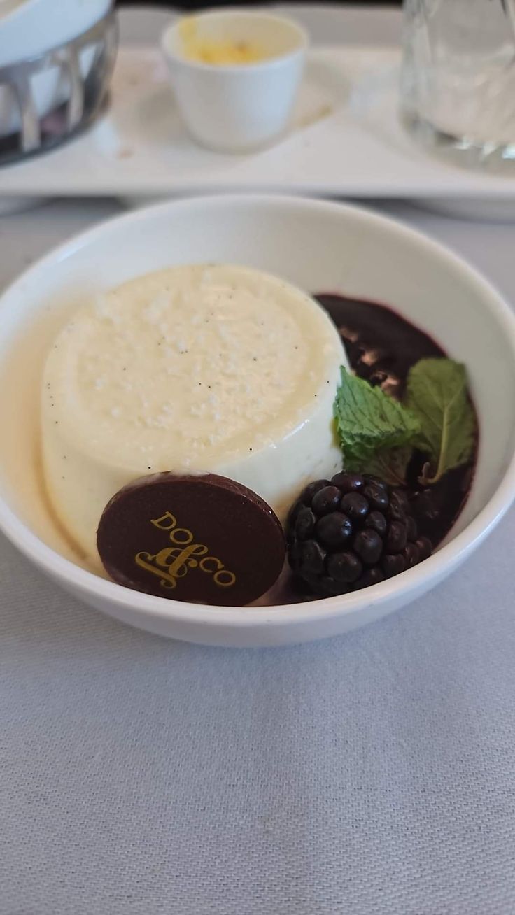 a white bowl filled with food on top of a table