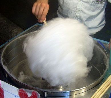 a man is washing his hands in a bucket with water and cotton on the side