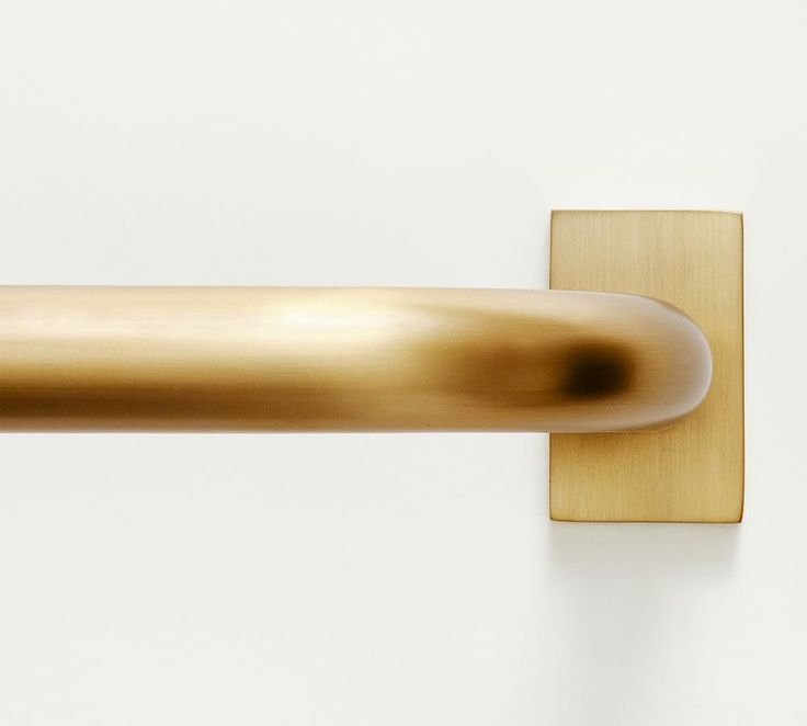 a close up of a metal handle on a white wall