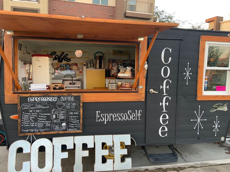 a coffee cart with writing on the side