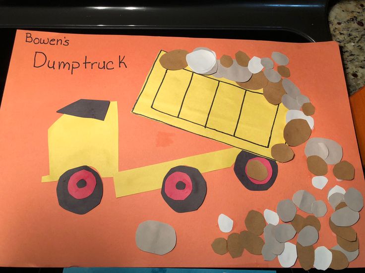 a paper construction truck is on top of a bulletin board with brown and white circles