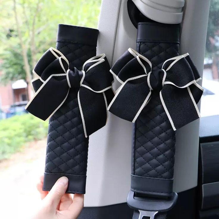 two black bows tied to the back of a car seat