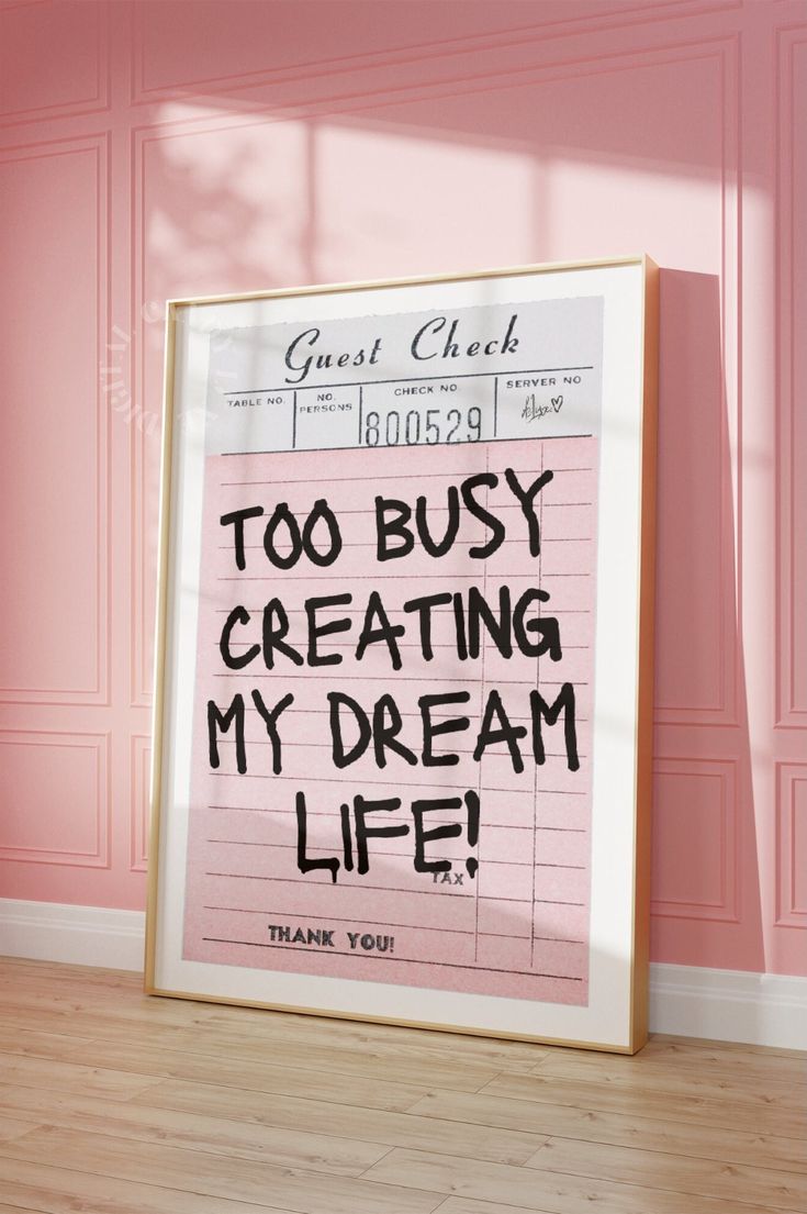 a pink poster with the words too busy creating my dream life written in black ink