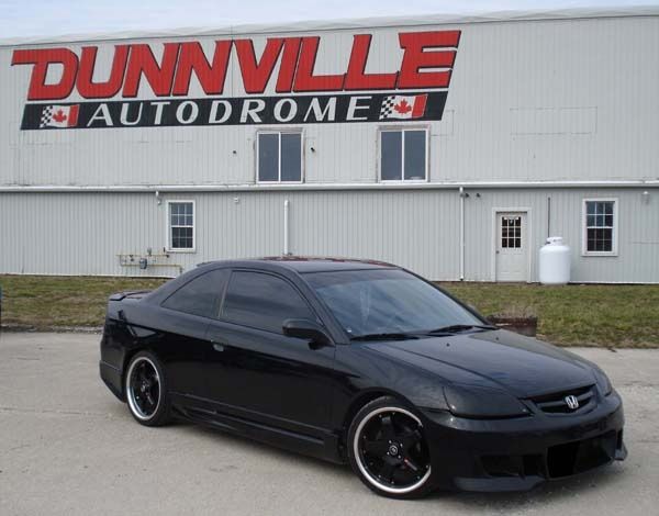 a black car parked in front of a building