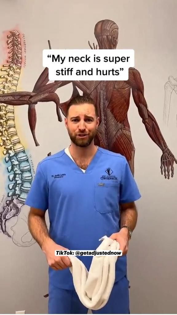 a man in scrubs standing next to a wall with an image of a skeleton