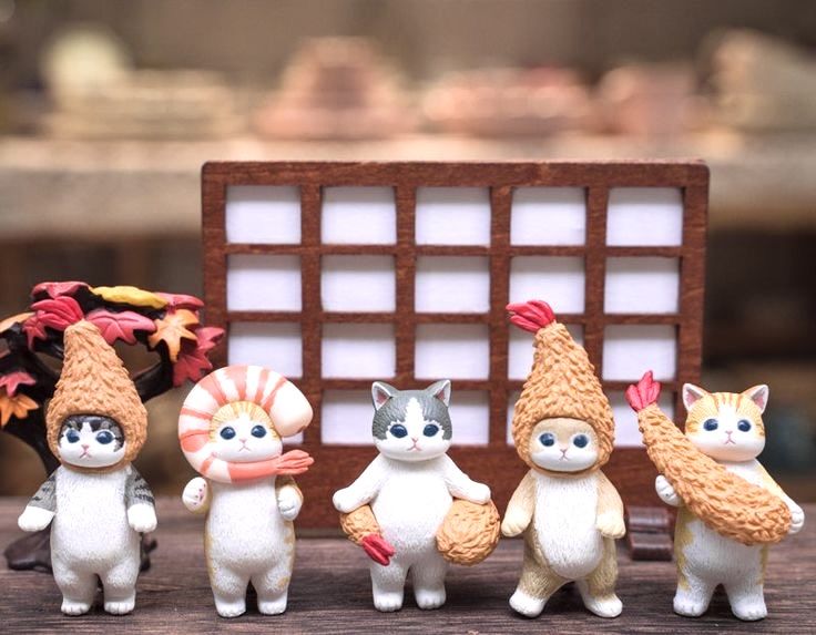 small figurines of cats and turkeys on a table