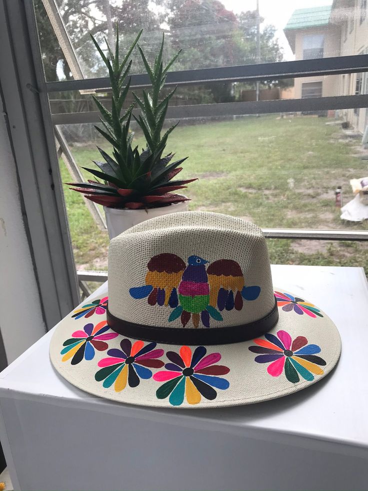 Mexican hand painted hat. The hat has a colorful floral design. Unique, colorful and fun to wear. The hat is made out of jute and it is light weight. Multicolor Flat Brim Panama Hat, Summer Multicolor Fedora With Curved Brim, Multicolor Summer Fedora With Curved Brim, Multicolor Wide Brim Panama Hat In Toquilla Straw, Summer Fedora With Multicolor Flat Brim, Multicolor Toquilla Straw Hat With Curved Brim, Multicolor Toquilla Straw Fedora Hat, Multicolor Fedora Hat In Toquilla Straw, Multicolor Toquilla Straw Fedora