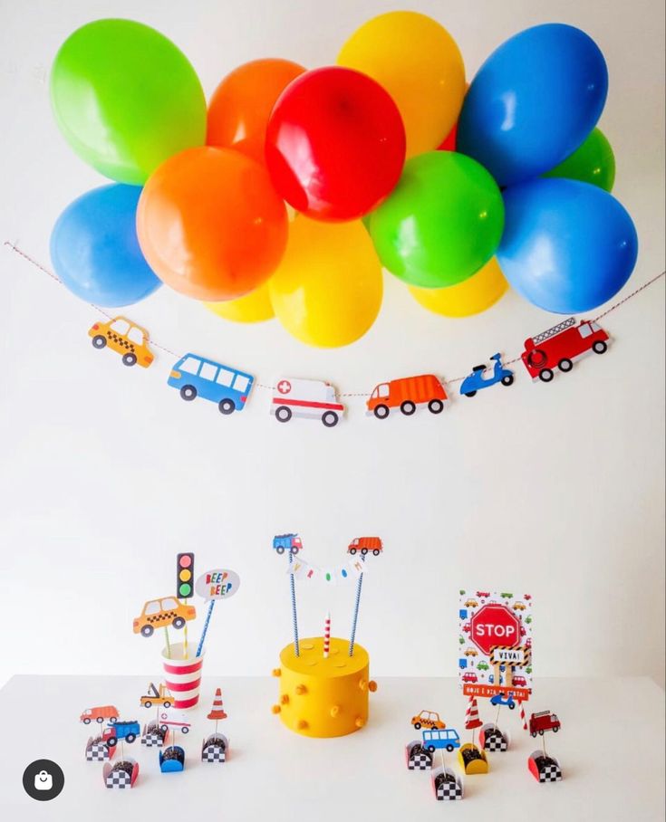 a birthday party with colorful balloons and cars