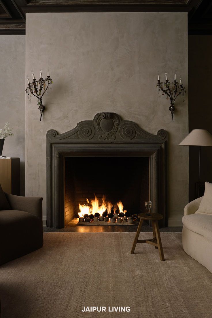 a living room filled with furniture and a fire place in the middle of the room