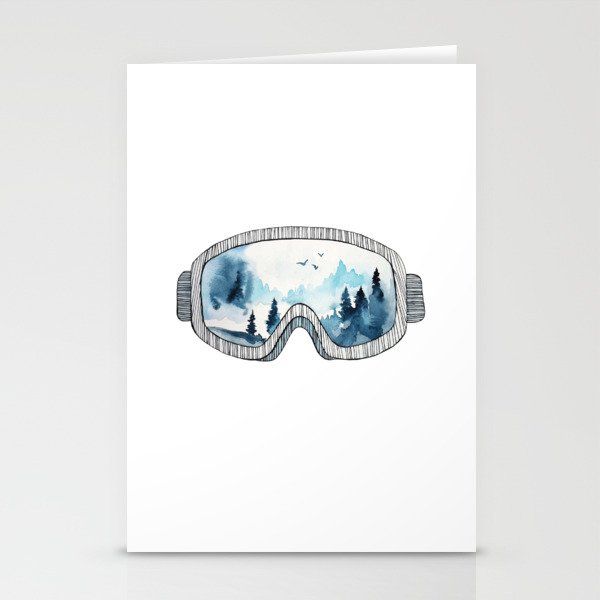 a card with an image of a pair of ski goggles in the snow and trees