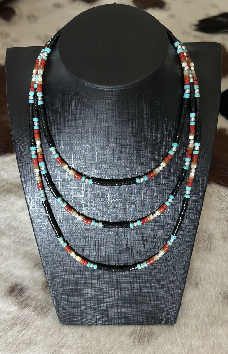 This set consists of items 169B, 170B and 171B These necklaces are made with genuine black onyx, turquoise, red coral and mother of pearl heishi beads. They are beautifully accented with 925 sterling silver pearl beads. $115 Black Heishi Beads Jewelry, Black Heishi Beads Necklace For Gift, Black Beaded Heishi Beads Necklace, Artisan Black Gemstone Beads, Handmade Black Heishi Beads, Artisan Black Round Bead Jewelry, Artisan Black Round Beads Jewelry, Artisan Black Jewelry With Polished Beads, Artisan Black Round Beaded Jewelry