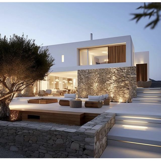 a modern house with stone walls and trees