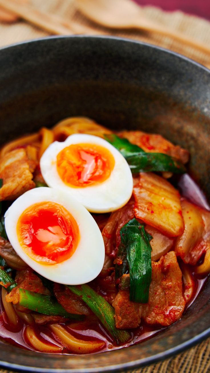 Thick chewy udon noodles in a spicy pork and kimchi broth topped with a soft boiled egg with a molten yolk. Spicy Udon Noodle Recipe, Spicy Udon Noodles, Udon Noodle Recipe, Kimchi Udon, Pork Udon, Asian Potluck, Kim Chee, Easy Kimchi, Kimchi Noodles