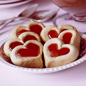 some heart shaped cookies are on a plate