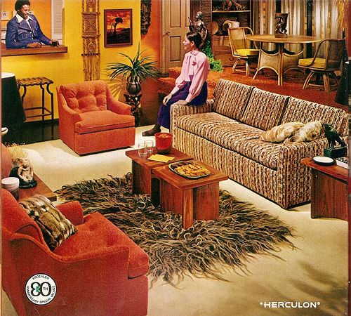 an old photo of a woman sitting on a couch in a living room filled with furniture