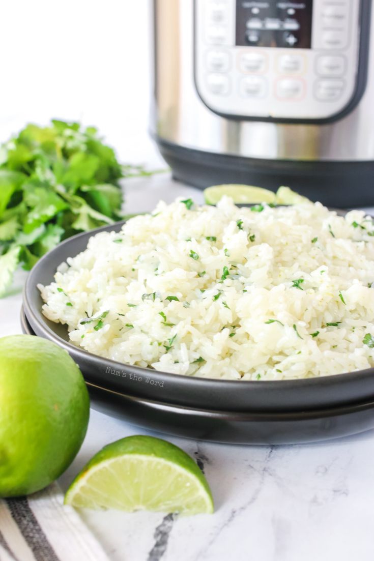 rice and limes on a plate next to an instant pot