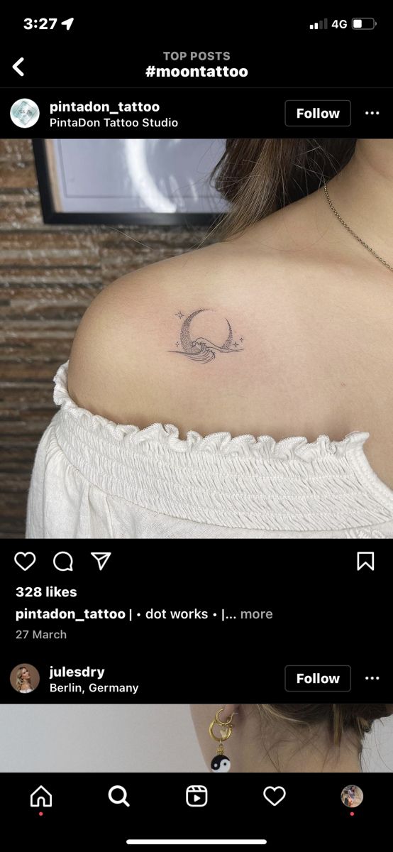 the back of a woman's shoulder with tattoos on it