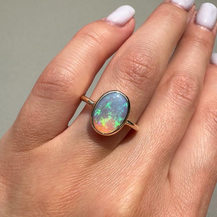 14K Yellow gold ring with Australian Crystal Opal Size: 6.25 Opal size: 11x8mm (1.4 ct) Metal: 14K yellow gold Band: 2mm comfort fit Stones: Australian opal (natural untreated stone) Oval Gold Opal Ring In 14k Gold, Fine Jewelry 14k Gold Opal Ring With Polished Finish, 14k Gold Opal Ring With Polished Finish, Oval Opal Ring In Yellow Gold Stamped 14k, Polished Yellow Gold Opal Ring, Hallmarked 14k Gold Opal Ring, Oval Shape, Hallmarked Oval Opal Ring In 14k Gold, Oval Hallmarked Opal Ring In 14k Gold, Oval Opal Ring In 14k Gold, Hallmarked