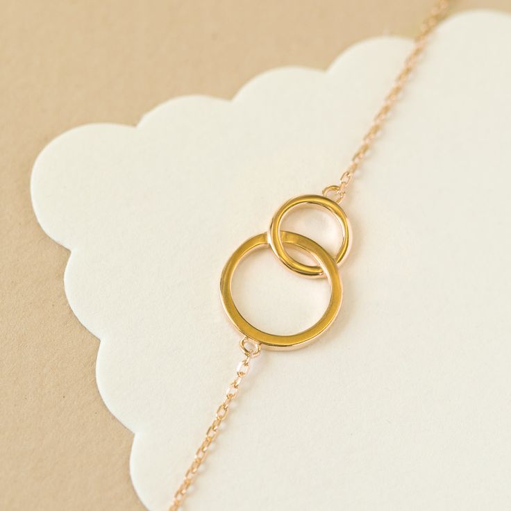 This classic Interlocking circles bracelet is minimal and elegant. This will be a gift your bridesmaid will love and want to wear everyday! Gold Vermeil .925 Sterling Silver Hypoallergenic, lead and nickel free Interlocking Circle: Length 0.75in (2cm) x Width 0.5in(1.3cm) Adjustable Chain Length 6-7.5in (15.2-19cm) Lobster Clasp Handcrafted in NYC #B311 Elegant Open Circle Everyday Jewelry, Circle Bracelet Gold, Minimalist Open Circle Gold Jewelry, Adjustable Circular Gold Bracelet, Adjustable Gold Circle Bracelets, Circle Bracelet, Chain Lengths, Gold Vermeil, Gold Bracelet