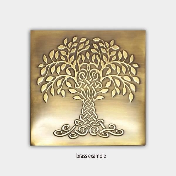 a metal plaque with a tree on it's side and the words brass example