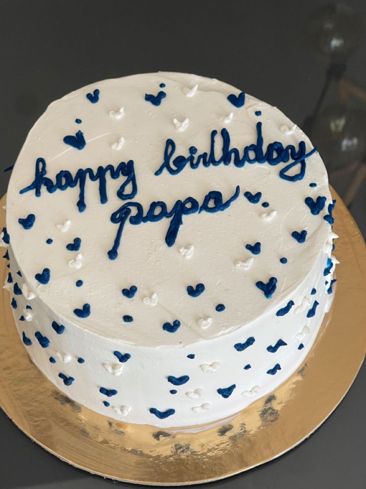 a white and blue birthday cake with the words happy birthday papa written on it