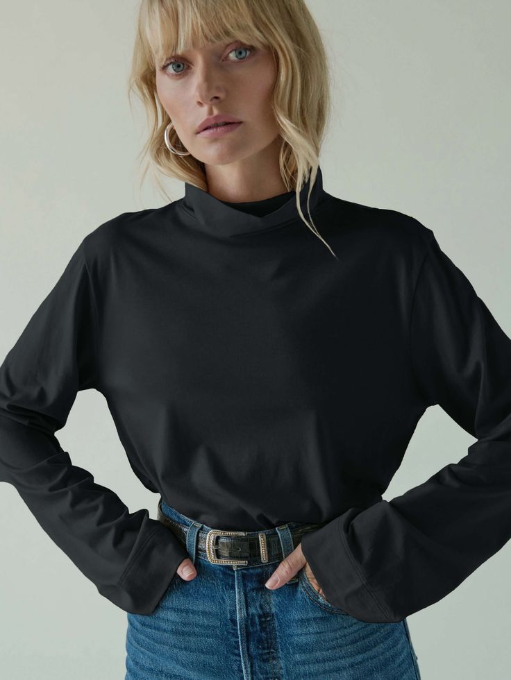 This versatile folded turtleneck top features side slits and a relaxed fit for that effortless cool factor without the fuss. (You might need every color). )This one comes in Jet Black.) | Neo Top in Jet Black | Ethical Essentials High Neck Solid Color Top For Layering, Relaxed Fit High Neck Tops, Fall Everyday Turtleneck Tops, Stretch Turtleneck Top For Everyday, Oversized Turtleneck Top For Work, Black Oversized High Neck Top, Chic High Neck Everyday Tops, Versatile Turtleneck Tops, Oversized Black High Neck Top