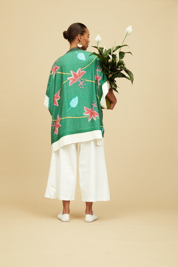 Elegant and striking, our Dhana Kimono is the perfect layer for summer days and effortless style. Throw it over a dress, jeans, or even a swimsuit, wear it on a night out, at the beach, or in the comfort of your home. The print on our Kimono is inspired by traditional Kanga textiles and is digitally printed. Made from 100% Rayon, a natural fibre, this Kimono is One Size and it is made in South Africa. We collaborated with a few local brands based in South Africa to create these special looks: Qi Digital Gift Card, Summer Ready, African Design, White Pants, Summer Days, Natural Fibers, Sunny Days, Effortless Style, Everyday Fashion