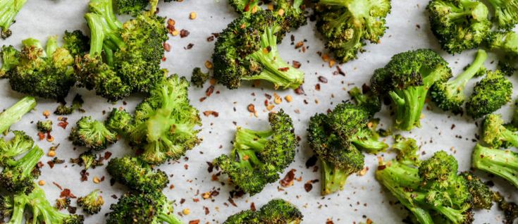 broccoli florets on a sheet of paper with seasoning sprinkles