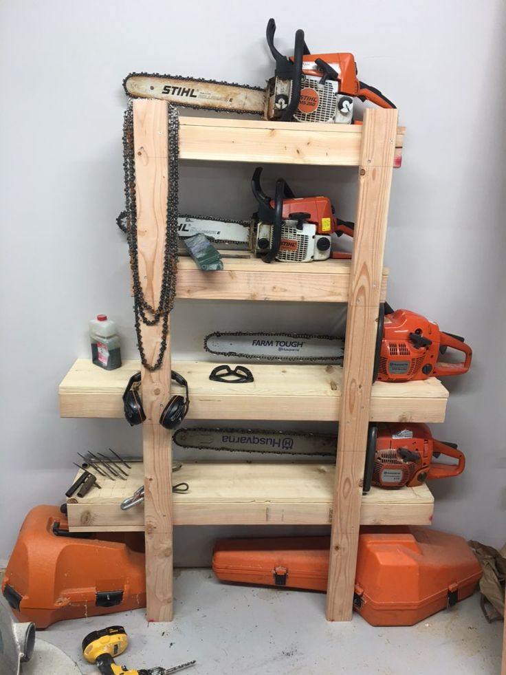 a wooden shelf with tools and chains on it